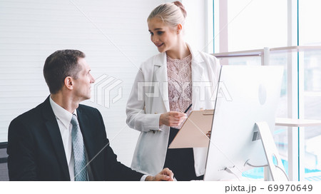 Two business people talk project strategy at office Two business people talk project strategy at office 69970649