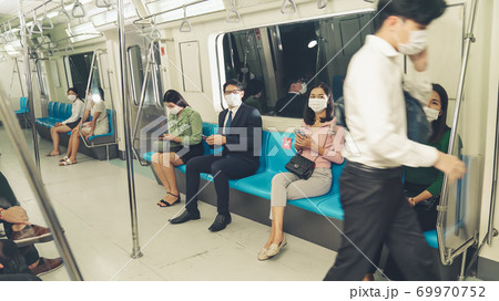 Crowd of people wearing face mask on a crowded public subway train travel 69970752