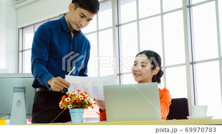 Two business people talk project strategy at office Two business people talk project strategy at office 69970783