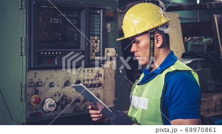 Smart factory worker using machine in factory workshop 69970861