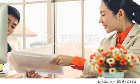 Two business people talk project strategy at office 69972332