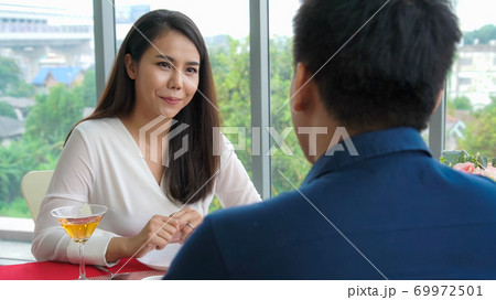 Happy romantic couple eating lunch at restaurant Happy romantic couple eating lunch at restaurant 69972501