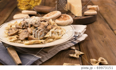 Pasta with mushrooms and tigelle. Butterfly pasta with parmesan and cheese sauce. Typical italian Pasta with mushrooms and tigelle. Butterfly pasta with parmesan and cheese sauce. Typical italian 69973151