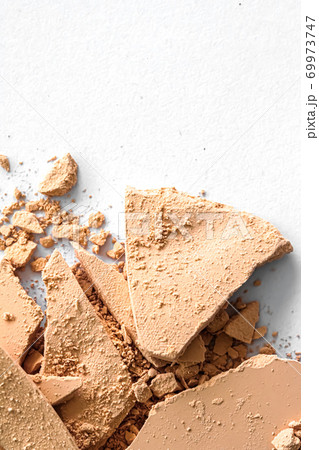 Beige eye shadow powder as makeup palette closeup isolated on white background, crushed cosmetics and beauty texture 69973747