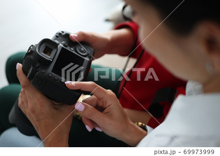 Female friends are looking at photographs on camera close-up Female friends are looking at photographs on camera close-up 69973999