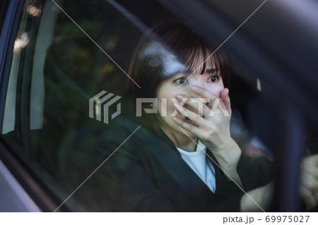 運転中に驚いた表情をする女性 69975027