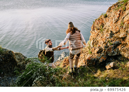 Assisting girlfriend to go down cliff Assisting girlfriend to go down cliff 69975426