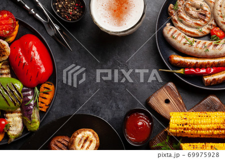 Grilled sausages and vegetables with spices and herbs 69975928