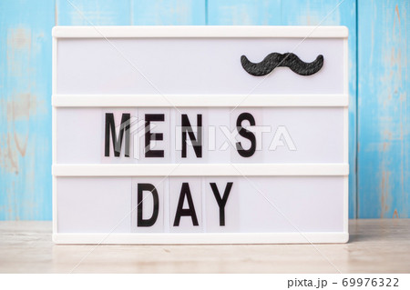 Men day text with mustache on lightbox. International Men day and Father day concept 69976322