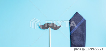 blue neckties and mustache on blue background. Happy Father's Day and International Men's Day concepts 69977271