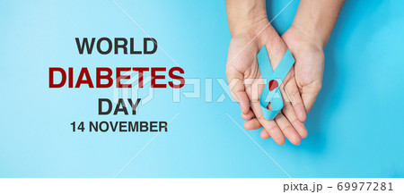 November World Diabetes day Awareness month, Woman holding light Blue Ribbon with blood drop for supporting people living, prevention and illness. Healthcare, prostate cancer day concept 69977281