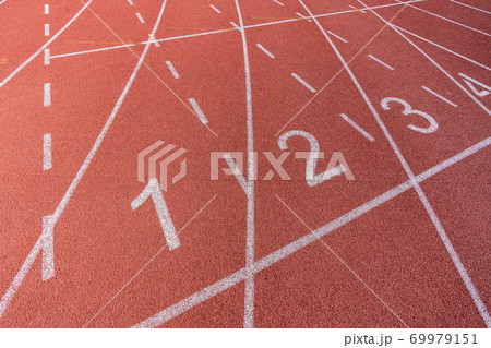 White painted lines and numbers on a running track in a athleticism and sports field.  69979151