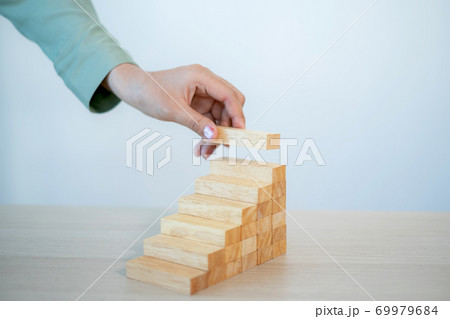 Businesswoman hand holding blocks wood game, Concept Risk of management and strategy plan, growth business success process and team work 69979684