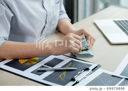 businesswomen bookkeeper hands count dollar note and doing account for paying tax on white desk in working office 69979896