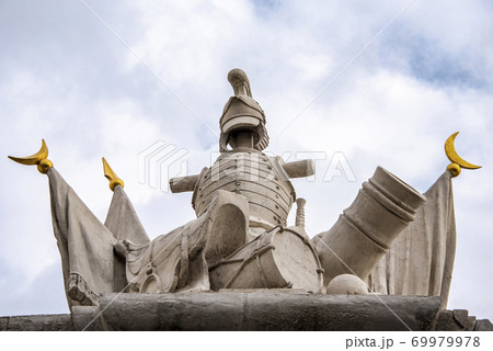 Sculptural composition on the gate of the Bratislava Castle depicting knight's armor, cannon and drum Sculptural composition on the gate of the Bratislava Castle depicting knight's armor, cannon and drum 69979978