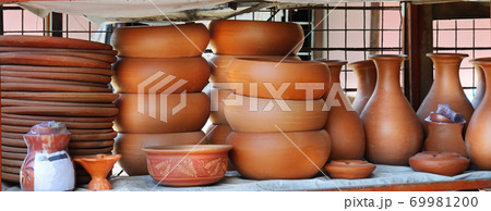 Shelves with ceramic dishware. Wide photo. 69981200