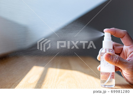 Young men use 70% alcohol spray to spray hands to get rid of bacteria and COVID-19 or CORONA viruses that destroy the respiratory system, COVID-19 virus protection concept. 69981280