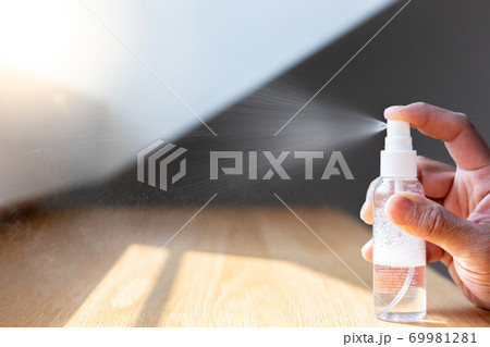 Young men use 70% alcohol spray to spray hands to get rid of bacteria and COVID-19 or CORONA viruses that destroy the respiratory system, COVID-19 virus protection concept. 69981281