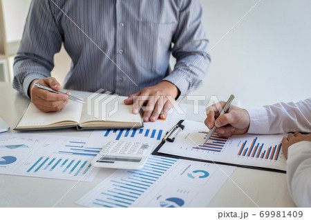 Business team meeting analyze financial graphs market growth reports And corporate income tax, Analysis of financial accounting and real estate investment concept. Business team meeting analyze financial graphs market growth reports And corporate income tax, Analysis of financial accounting and real estate investment concept. 69981409