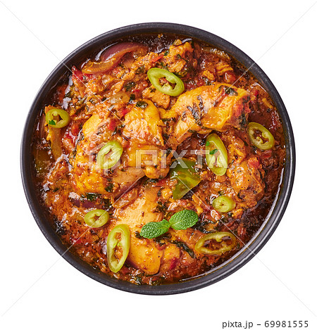 A Chicken Patiala in black bowl isolated on white. Murg Patiala is indian cuisine curry dish A Chicken Patiala in black bowl isolated on white. Murg Patiala is indian cuisine curry dish 69981555