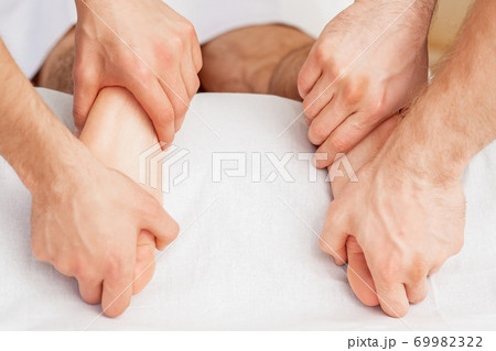 Massage of soft bare feet. 69982322