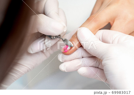 Manicure master uses an electric nail machine 69983017
