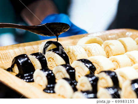 Chef cooking, Chef preparing food in the kitchen, Chef decorating dish, closeup. 69983155