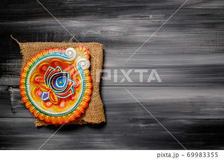Happy Diwali Greeting Card made using sweets, or fire crackers or Diya or flowers. 69983355