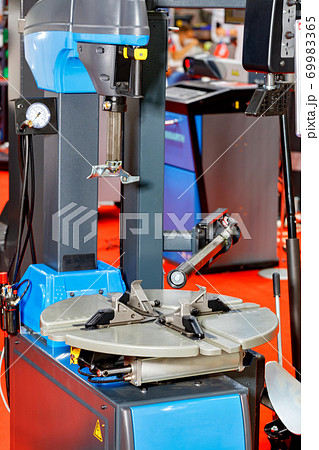 Modern equipment at the service station for dismantling rubber tires for automotive vehicles. Modern equipment at the service station for dismantling rubber tires for automotive vehicles. 69983365