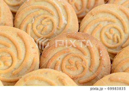 Close-up of a large number of round cookies with coconut filling Close-up of a large number of round cookies with coconut filling 69983835