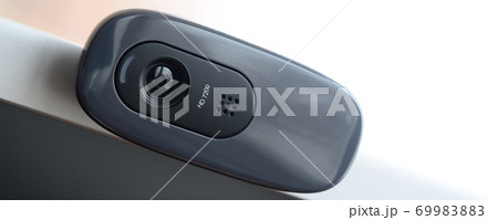 A modern web camera is installed on the body of a flat screen monitor. Device for video communication and recording of high quality video A modern web camera is installed on the body of a flat screen monitor. Device for video communication and recording of high quality video 69983883