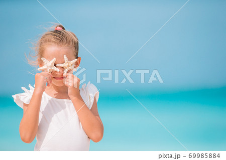 Cute little girl at beach during summer vacation Cute little girl at beach during summer vacation 69985884