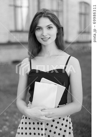 Young girl student in dress. Black and white photo. BW 69986311