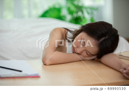 Asian young woman sleep on work table in bedroom 69993530