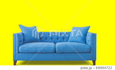 blue sofa isolated on yellow background 69994722