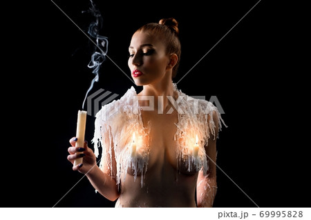 Naked female model with candles on breast Naked female model with candles on breast 69995828