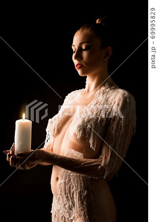 Topless woman look at carrying candle Topless woman look at carrying candle 69995829