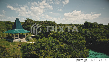 Indonesia landmark for tourists of modern building at green landscape. Architecture attraction Indonesia landmark for tourists of modern building at green landscape. Architecture attraction 69997423