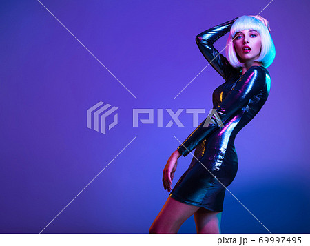 Stylish blonde in shiny dress. Full-length portrait of beautiful  fashionable woman in shining dress, space concept. Art portrait  of  an young attractive model. Fantasy style. Glamour fashion girl 69997495