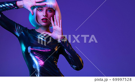 Full-length portrait of beautiful fashionable woman in shining dress, space concept. Art portrait of an young attractive model. Stylish blonde in shiny dress. Fantasy style. Glamour fashion girl Full-length portrait of beautiful fashionable woman in shining dress, space concept. Art portrait of an young attractive model. Stylish blonde in shiny dress. Fantasy style. Glamour fashion girl 69997528