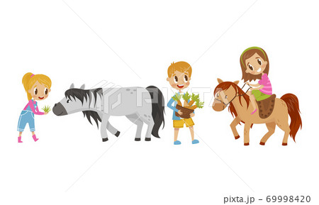 Cute Kid Feeding Their Horses With Grass And Stock Illustration
