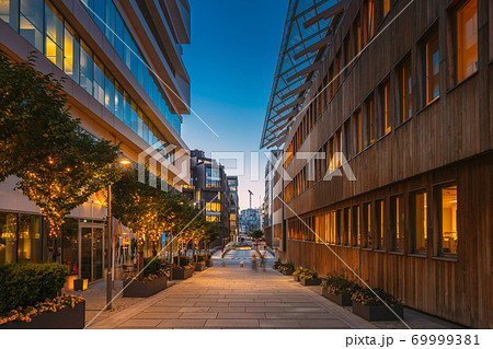 Oslo, Norway. Night View Embankment And Residential Multi-storey Houses In Aker Brygge District. Summer Evening. Residential Area Reflected In Sea Waters. Famous And Popular Place Oslo, Norway. Night View Embankment And Residential Multi-storey Houses In Aker Brygge District. Summer Evening. Residential Area Reflected In Sea Waters. Famous And Popular Place 69999381
