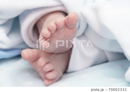 Detail shot of a newborn baby feet peacefully Detail shot of a newborn baby feet peacefully 70002332