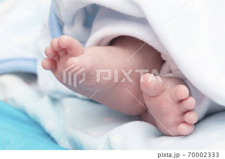 Detail shot of a newborn baby feet peacefully Detail shot of a newborn baby feet peacefully 70002333