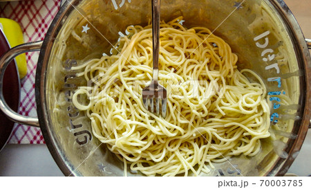 Large bowl with freshly cooked pasta spaghetti and metal fork closeup Large bowl with freshly cooked pasta spaghetti and metal fork closeup 70003785