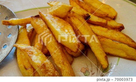 Yellow home made french fries on the white plate 70003973
