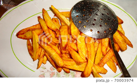 Yellow home made french fries on the white plate 70003974