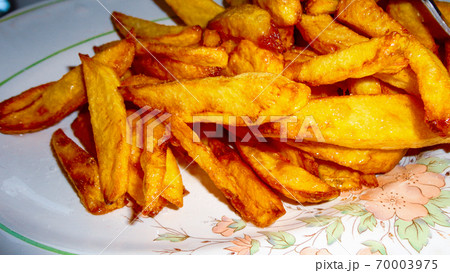 Yellow home made french fries on the white plate 70003975