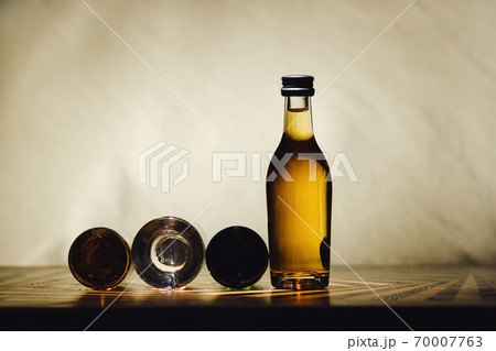 different alcohol bottles are on the table on a light background 70007763