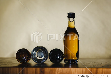 different alcohol bottles are on the table on a light background 70007764